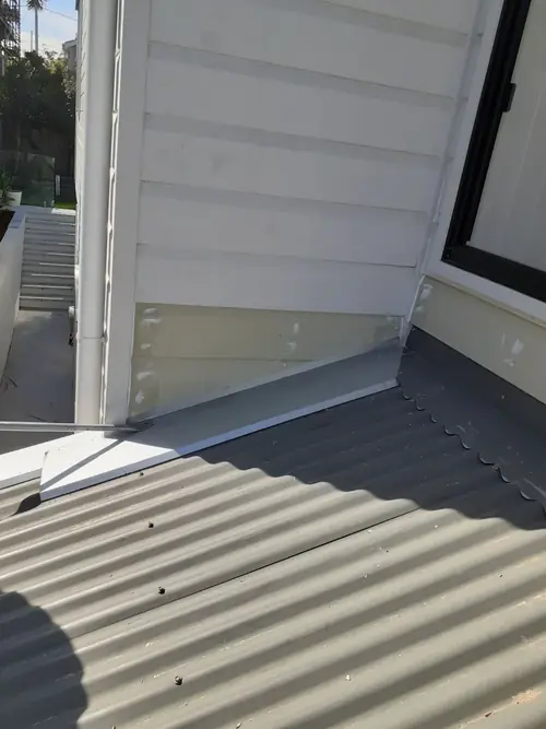 Reinstallation of a flashing that has been installed incorrectly and created a leak.