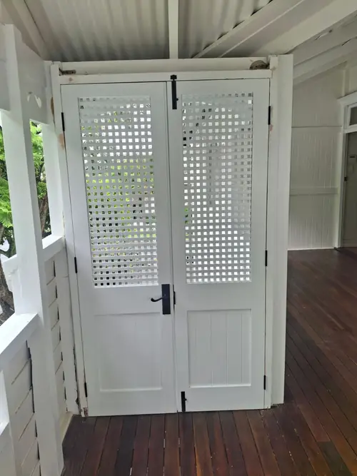 Installation of new lattice doors with new hardware. The old frame has been modified / adjusted to be square and plumb .