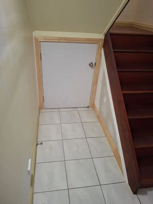Creation of an enclosed storage under a stair . Matching architraves and skirting have been installed The owner will replace the other handles that's why it's a different colour .