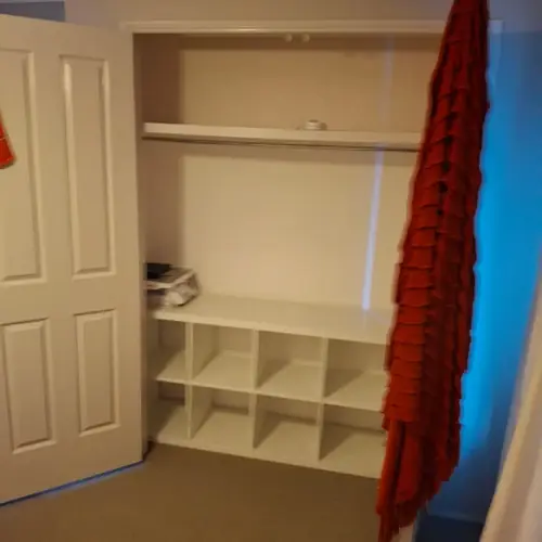 We've replaced those wardrobe swing doors with sliding doors. We've also built a new set of shelves in each one.