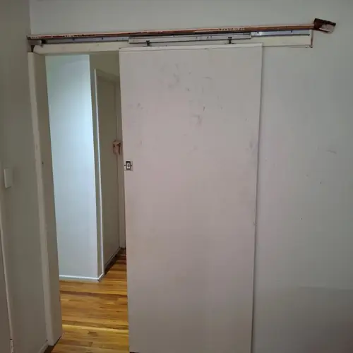 Replacement of the sliding door with a swing door. The handle has been installed to that height to match the other doors. The light switch has been moved on the other side. The old light switch hole has been patched.