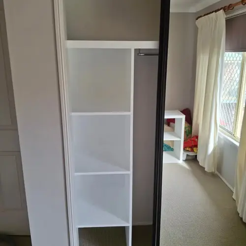 We've replaced those wardrobe swing doors with sliding doors. We've also built a new set of shelves in each one.