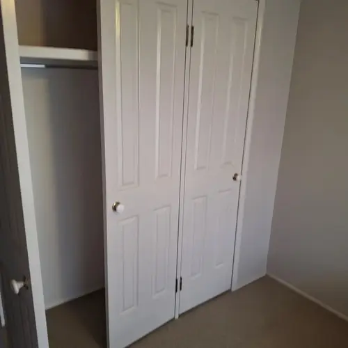 We've replaced those wardrobe swing doors with sliding doors. We've also built a new set of shelves in each one.