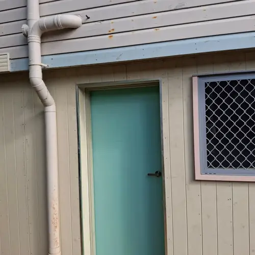 Going from tarps to a house. The concrete was at the same height from inside to outside so it had to be cut to create a stepdown for water infiltration. A new frame has been built and a termite barrier has been installed with a z flashing. A new door and window have been installed as well. More to come..