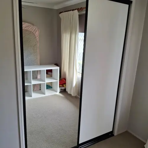 We've replaced those wardrobe swing doors with sliding doors. We've also built a new set of shelves in each one.