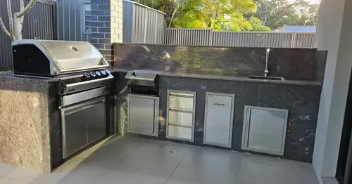 We've built an external kitchen with a steel frame, cement sheet (easylap) cladding for the tiles. We've installed the stainless steel doors, drawers, rubbish bin and shelves.