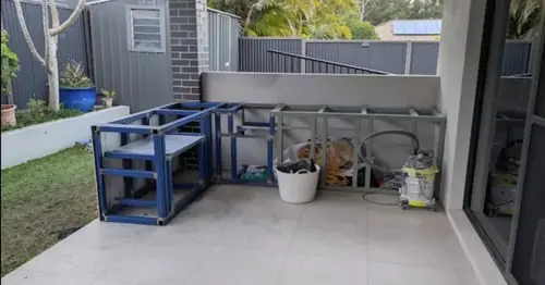 We've built an external kitchen with a steel frame, cement sheet (easylap) cladding for the tiles. We've installed the stainless steel doors, drawers, rubbish bin and shelves.