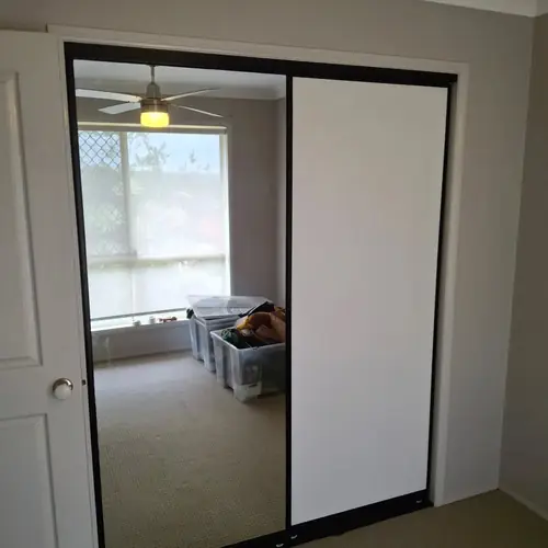 We've replaced those wardrobe swing doors with sliding doors. We've also built a new set of shelves in each one.